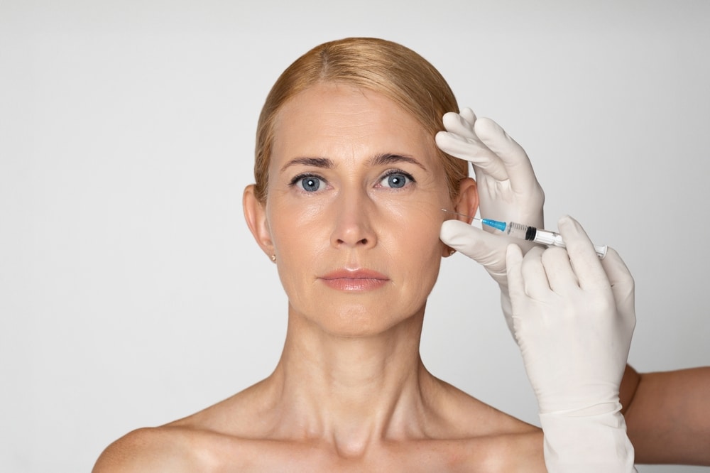 Beautiful blonde woman with facial collagen loss gets Sculptra injections